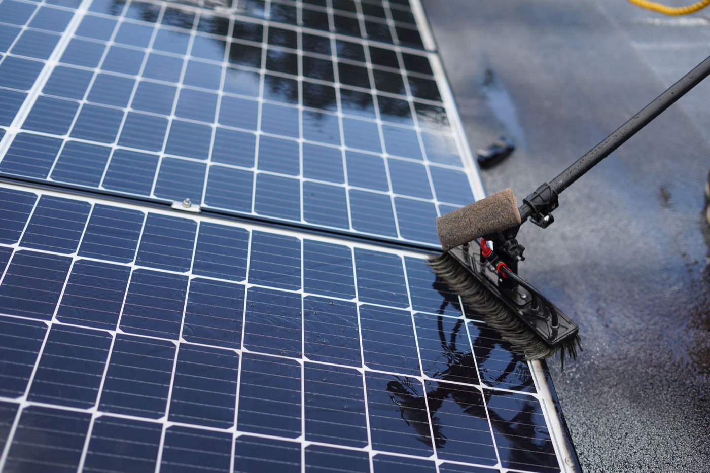 High-pressure water jets cleaning a solar panel